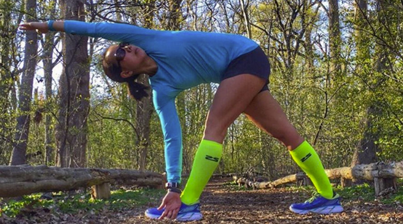 Woman stretching in zensah tech+ compression socks