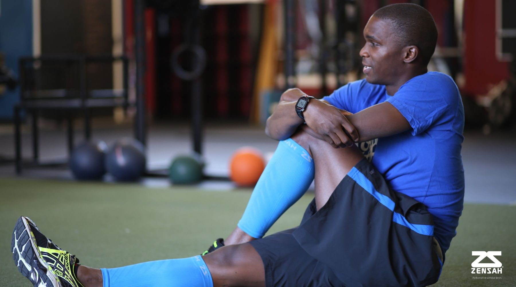 Zensah athlete wearing compression leg sleeves and stretching