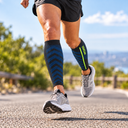 Runner wearing Featherweight Compression Leg Sleeves in Charcoal/Blue