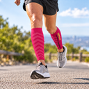 Runner wearing Featherweight Compression Leg Sleeves in Fuchsia