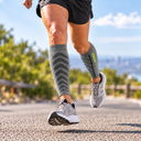Runner wearing Featherweight Compression Leg Sleeves in Heather Grey