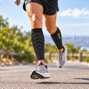 Runner wearing Featherweight Compression Leg Sleeves in Midnight Black